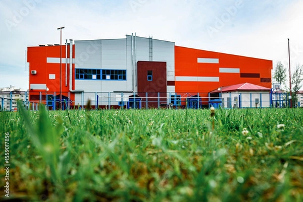 Fototapeta Orange sports and recreation complex building in small town.