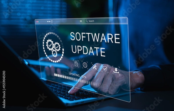 Obraz Software Update and System Upgrade Concept. Person holding phone while using laptop with software update progress interface and security, technology maintenance, application upgrades, system security.