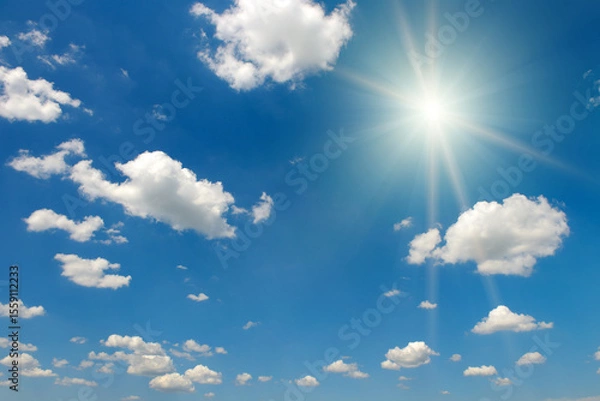 Fototapeta Bright midday sun and beautiful blue sky with clouds.