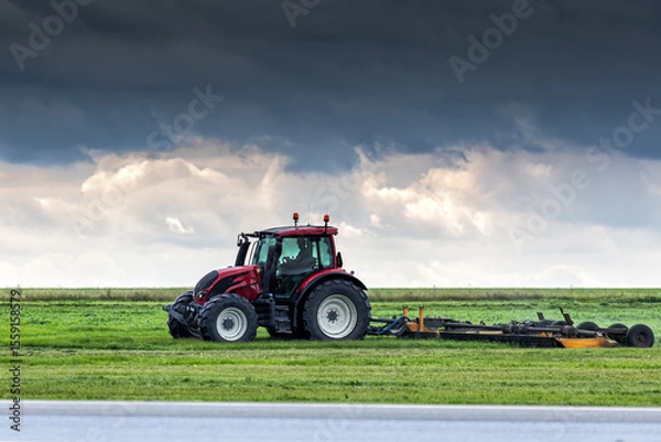 Obraz Wheel tractor with lawn mower by the road