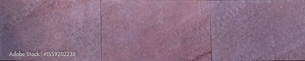 Fototapeta Purple stone tiles with rough texture and rectangular pattern on exterior wall



