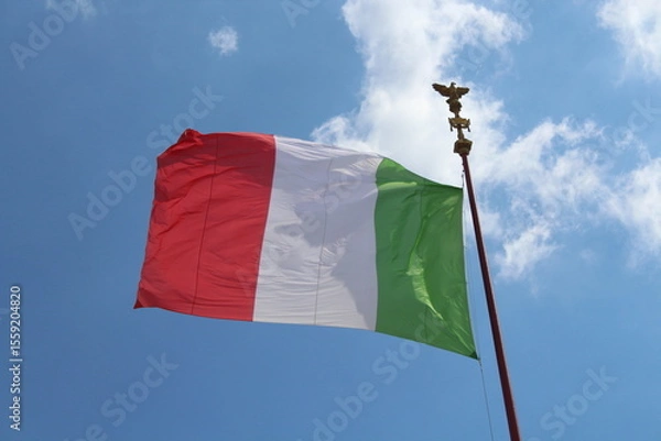 Obraz Italian flag in cloudy sky. waving in the sky. Italian flag in a wind on a cloudy blue sky background in Rome