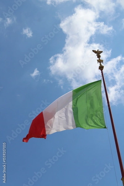 Obraz Italian flag in cloudy sky. waving in the sky. Italian flag in a wind on a cloudy blue sky background in Rome