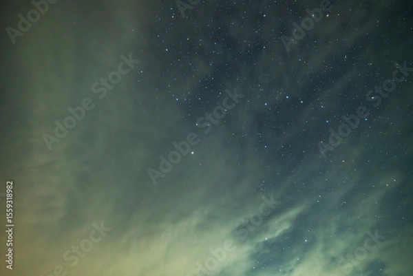 Fototapeta Beautiful night sky background, with long exposure clouds, starry sky.