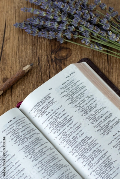 Obraz Open holy bible book on wooden background with lavender flowers. Christian studying and reading concept.