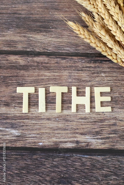 Obraz Tithe wooden text with ripe wheat on rustic background. Top view. Christian biblical concept.