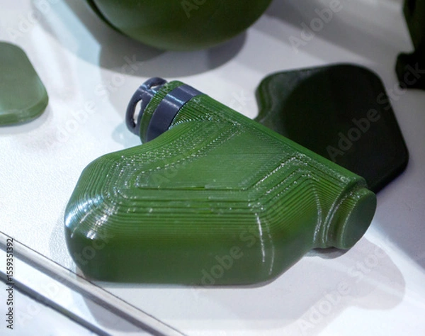 Fototapeta Mina Petal printed on 3D printer. Anti-personnel explosive mine created on 3D printer from molten plastic. Prototype of ammunition printed on 3D printer. Innovation modern new 3d printing technology