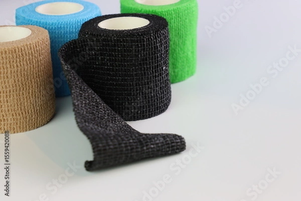 Fototapeta Different colors of cohesive bandages. Non adhesive bandage in a white background with different colors