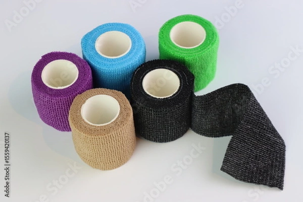 Fototapeta Different colors of cohesive bandages. Non adhesive bandage in a white background with different colors