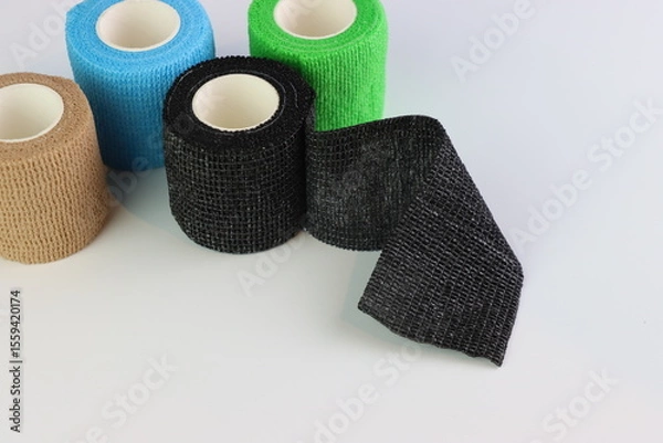 Fototapeta Different colors of cohesive bandages. Non adhesive bandage in a white background with different colors