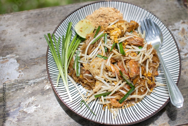 Fototapeta Pad Thai with fresh shrimp on a plate, close-up photo