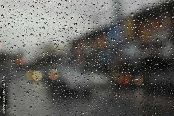 Fototapeta rain in the city blur background, water drop on windshield of car