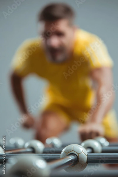 Fototapeta dynamic portrait of table football player warming up positioned on side of frame