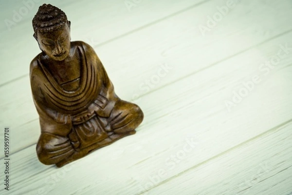 Obraz Close-up of Buddha statue on wooden floor