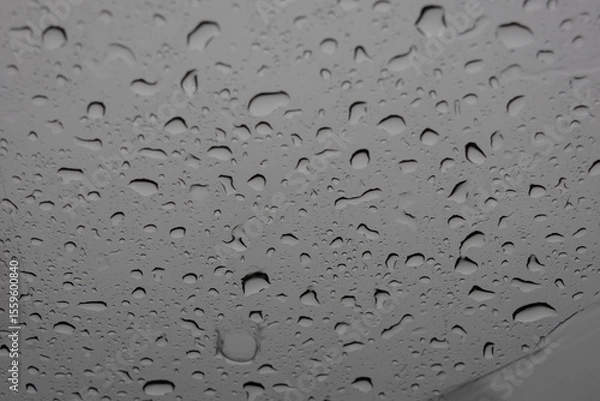 Obraz close-up, full-frame shot of numerous water droplets of varying sizes clinging to a glass surface