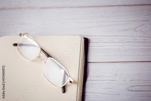 Obraz Eyeglasses on textured wooden table