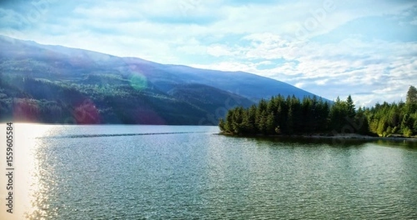 Obraz Idyllic view of river by mountains