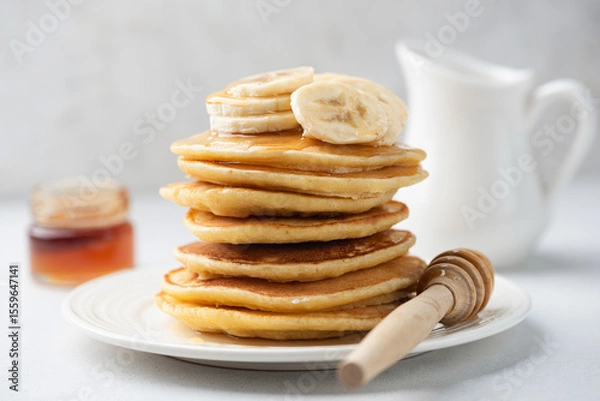 Fototapeta Healthy vegan banana oatmeal pancakes stack over light grey concrete background, side view