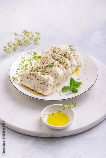 Obraz Raw halloumi, Cyprus squeaky cheese with herbs and olive oil prepared for grill