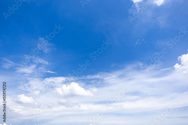 Fototapeta clear blue sky background,clouds with background, Blue sky background with tiny clouds. White fluffy clouds in the blue sky. 
