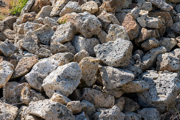Fototapeta Pile of porous volcanic tuff stones in sunlight. Traditional building material in Tokaj wine region, Slovakia. Natural texture and rough surface.