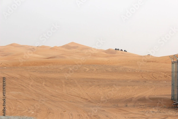 Fototapeta Dubai desert safari in sunset light. Off road safari in sand desert, Empty Quarter Desert in United Arab Emirates. Off roader on dunes in Rub al Khali desert.