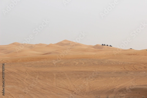 Fototapeta Dubai desert safari in sunset light. Off road safari in sand desert, Empty Quarter Desert in United Arab Emirates. Off roader on dunes in Rub al Khali desert.