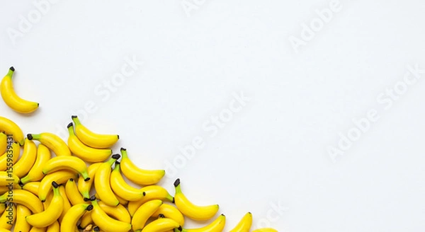 Fototapeta Mini Bananas on White Background – Creative Fruit Composition with Copy Space
