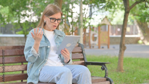 Obraz Young Woman Expressing Disbelief While Using a Tablet