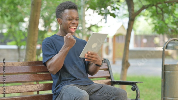 Obraz African American Man Celebrating with Surprise to Content on a Tablet