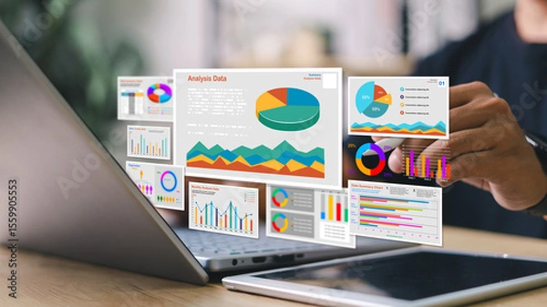 Fototapeta Businessman analyzing digital data dashboards on laptop with floating charts, graphs, and statistics. Concept of data analytics, business intelligence, and KPI tracking.