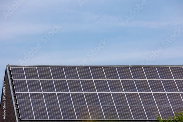 Obraz Green energy concept, A solar cell panel on the rooftop under blue sky, Photovoltaic cell is an electrical device that converts the energy of light directly into electricity by the photovoltaic effect