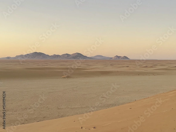 Fototapeta Vast Desert Landscape at Sunset Sand Dunes and Distant Mountains