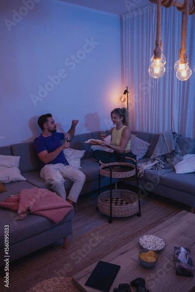 Obraz Relaxed Couple Enjoying Wine at Home in the Evening