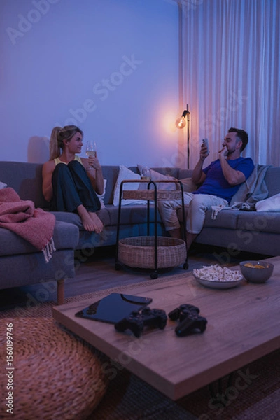 Obraz Man Taking Photo of Girlfriend During Cozy Evening with Wine and Snacks