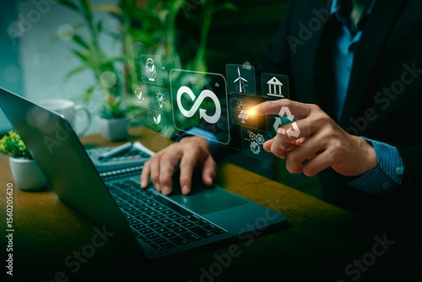Obraz Businessman Using Laptop and Touching Virtual Screen with Infinity Symbol for Circular Economy, Highlighting Sustainable Development, Renewable Energy, Recycling, and Green Technology