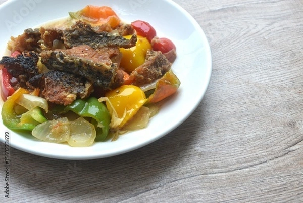 Obraz deep fried slice mango fish with bell pepper and onion in black pepper sauce on plate 