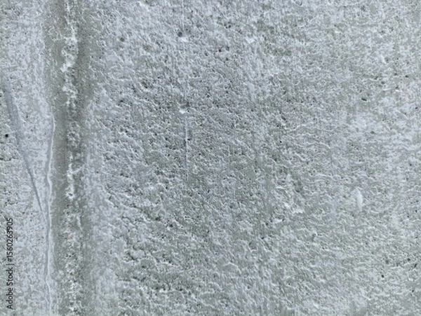 Fototapeta Rough White Concrete Wall Surface. Close-up of a rough white concrete wall texture with natural imperfections and weathered surface, ideal for design backgrounds and industrial themes