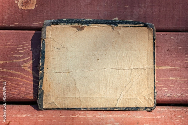 Obraz Vintage empty paper lies on the old wooden texture of bench