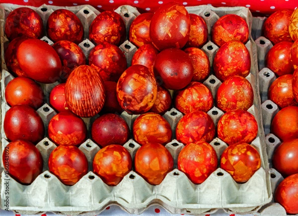 Obraz Red coloured cooked Easter chicken eggs sold outside on market during festive period