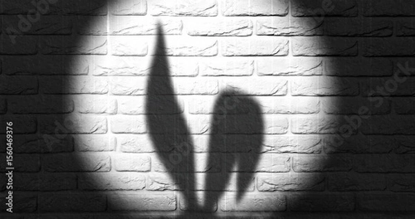 Fototapeta Shadows of cartoon bunny ears are projected against a brick wall