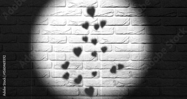 Fototapeta Hearts cast shadows on a white textured wall, illuminated by a  spotlight