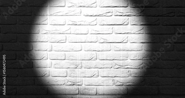 Fototapeta A vivid spotlight illuminates a section of a textured brick wall