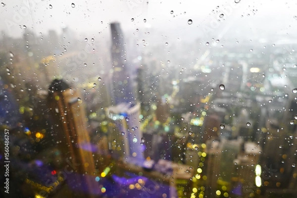 Obraz Highrise Buildings or Skyscrapers in Big City During Rainstorm with Rain Drops on Window