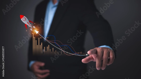 Obraz Businessman pointing at data graph with a rocket icon symbolizing rapid startup growth, business success, financial performance, innovation strategy, Accelerated market expansion for new ventures.