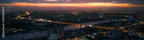 Fototapeta Expressway, Beautiful top view time-lapse of car traffic at roundabout lane and buildings, Urban cityscape concept or abstract of advanced innovation, financial technology, energy power, highway