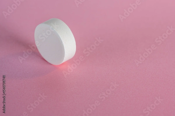 Obraz White medicine tablet standing on side on isolated on pink pastel background as macro 1