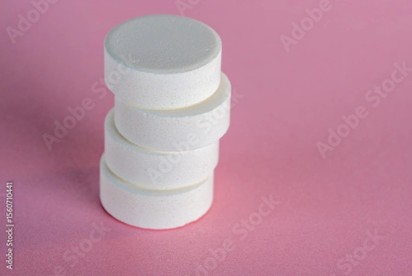 Obraz Shifted staple of four white medicine tablets laying isolated on pink pastel background as macro 1