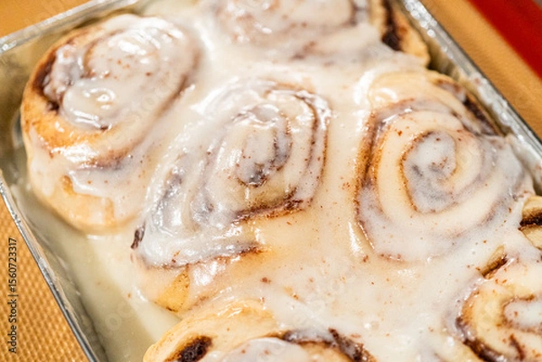 Obraz Freshly Baked Cinnamon Rolls Cooling on Stove Top
