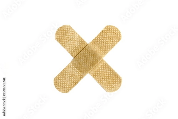 Fototapeta On a white isolated background there is an adhesive plaster in the form of a cross.	